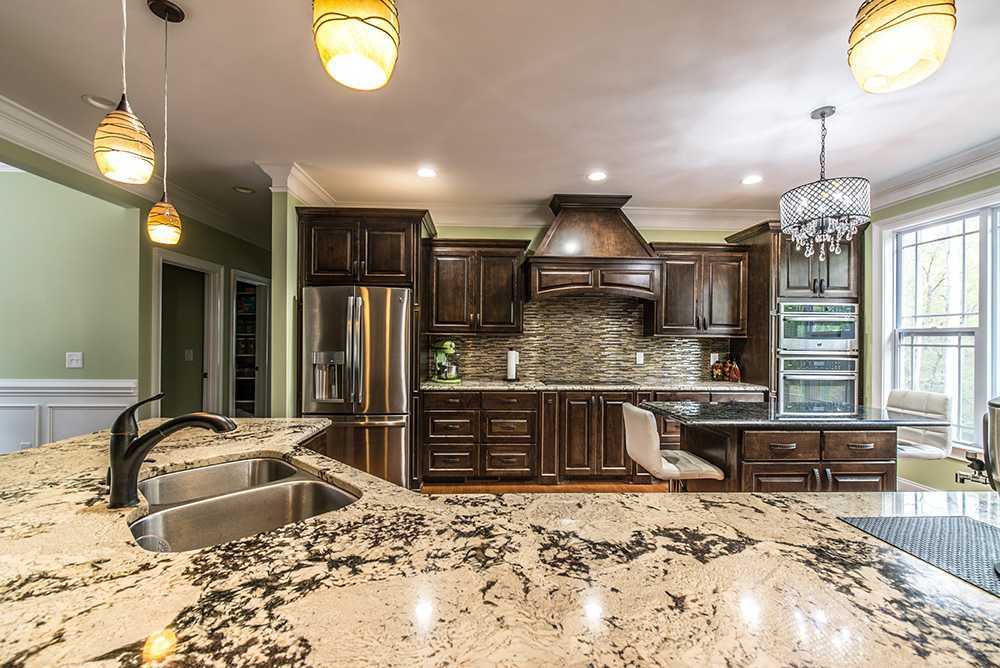 Delicatus White Granite Kitchen Countertop with Traditional Cabinets